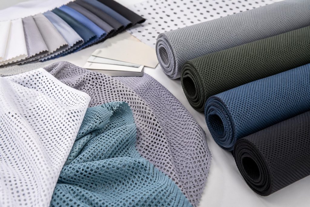 Lightweight polyester fabric rolls and open mesh swatches for wholesale sourcing
