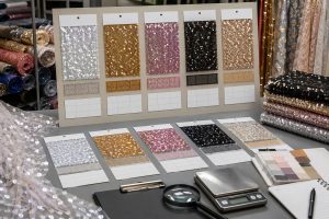 Wholesale sequin fabric supplier comparison with sample cards and quality tools