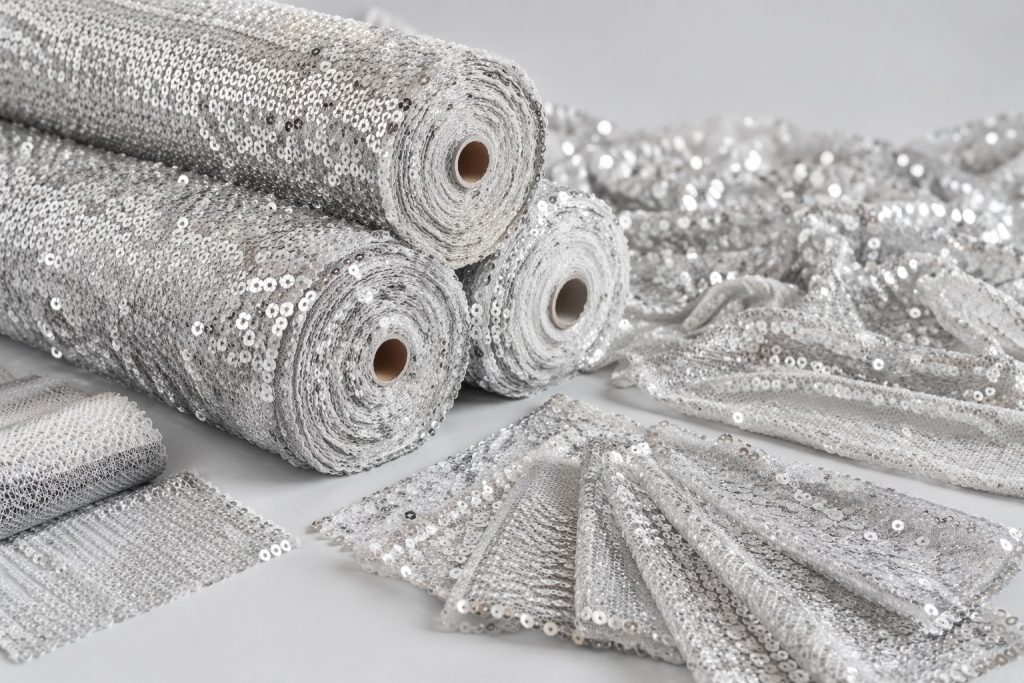 Silver sequin mesh fabric rolls and swatches for fashion and event wholesale buyers