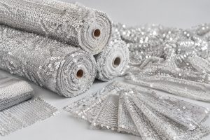 Silver sequin mesh fabric rolls and swatches for fashion and event wholesale buyers