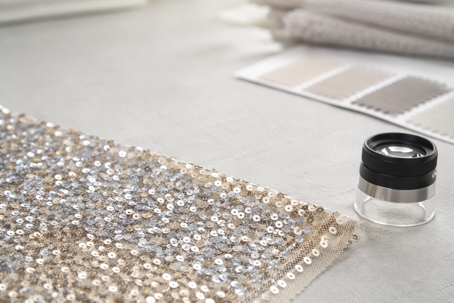 Sequin fabric quality inspection close-up showing stitch density and attachment detail