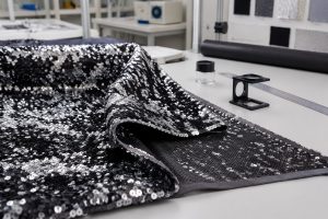Polyester sequin fabric mesh backing inspected for wholesale garment sourcing