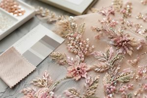 High-quality embroidery fabric detail with beadwork and sequin stitching for B2B sourcing