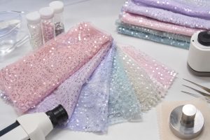 Pastel sequin mesh fabric on a professional safety quality inspection table