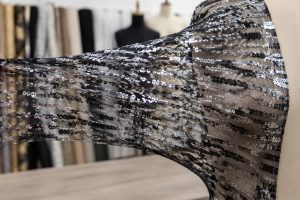 Stretch sequin mesh fabric showing elastic recovery for dancewear and fitted dress wholesale sourcing