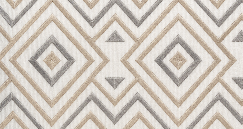 Clean modern geometric embroidery fabric with crisp high-density satin-stitch diamond and chevron patterns