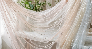Lightweight sheer sequin mesh fabric draped in translucent ombre waves with shimmering micro sequins