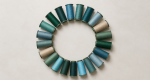 Thread spools in coordinated earth tones arranged for homogeneous recycled embroidery materials