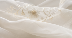 Light ivory organza fabric with translucent delicate embroidery, airy and sheer