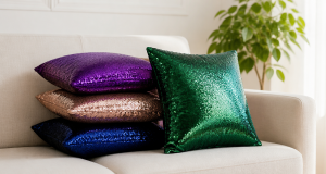Four sequin throw pillows in royal purple, rose gold, navy and emerald arranged on a cream sofa in a bright living room with a green plant
