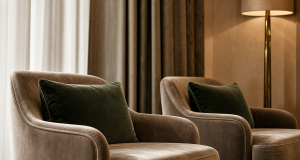 Plush taupe and deep green upholstered armchairs in an elegant hotel lobby for hospitality fabric sourcing